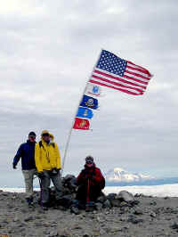 Jim, Bob and Jeanne pose at the top, in front of Mt. Rainier
