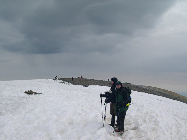 Across a small snow field to the true summit